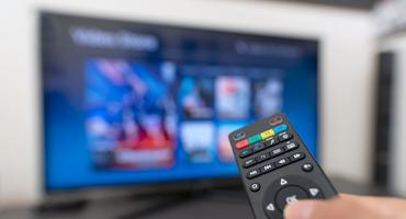 Ein TV Stick streamt verschiedene Inhalte auf den Fernseher.