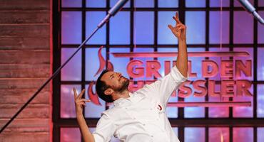 Steffen Henssler in seiner Kochshow „Grill den Henssler" tanzend vor dem Logo der Show